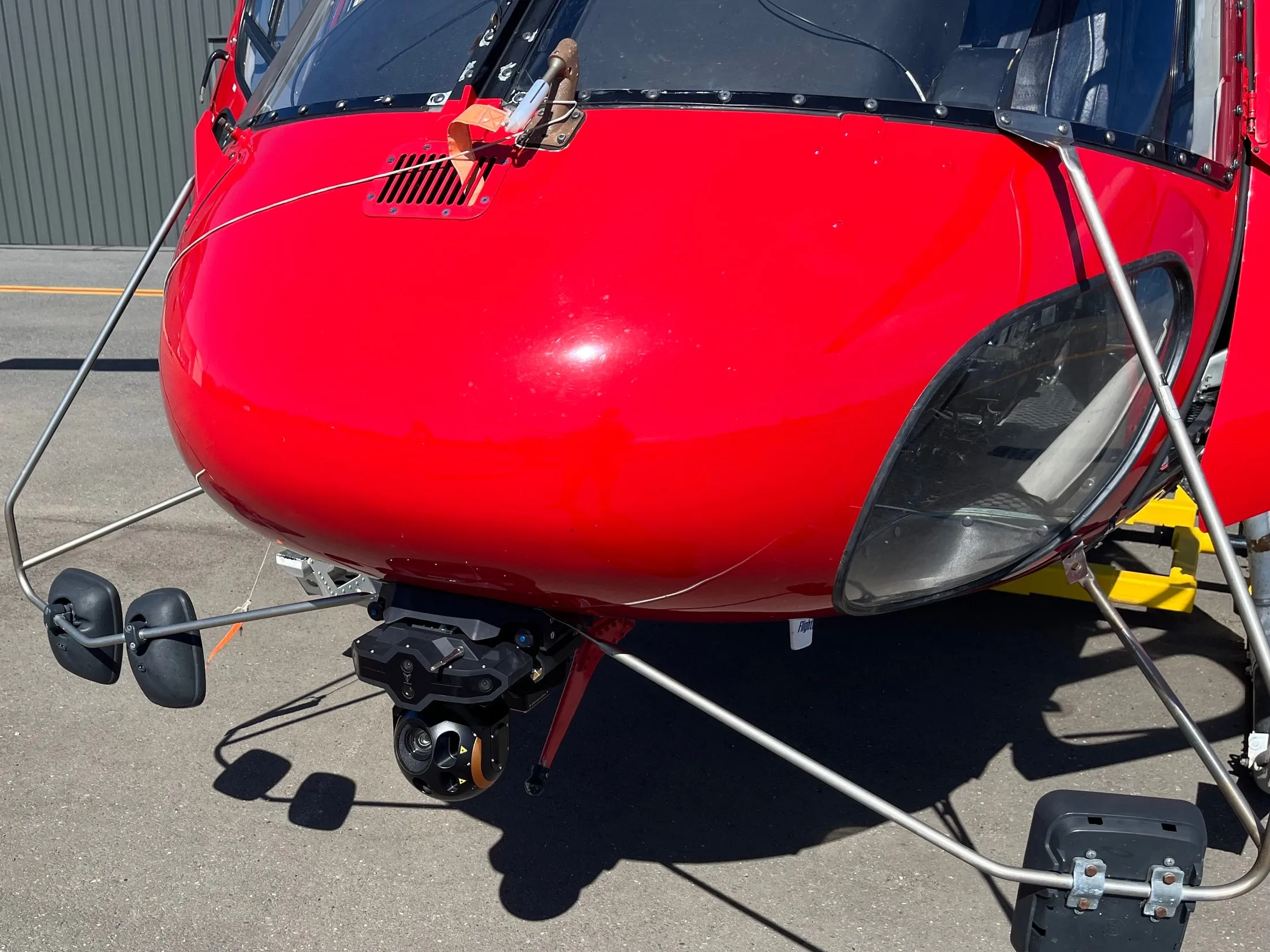 VoxVision sensors and gimbal installed beneath a red helicopter's nose