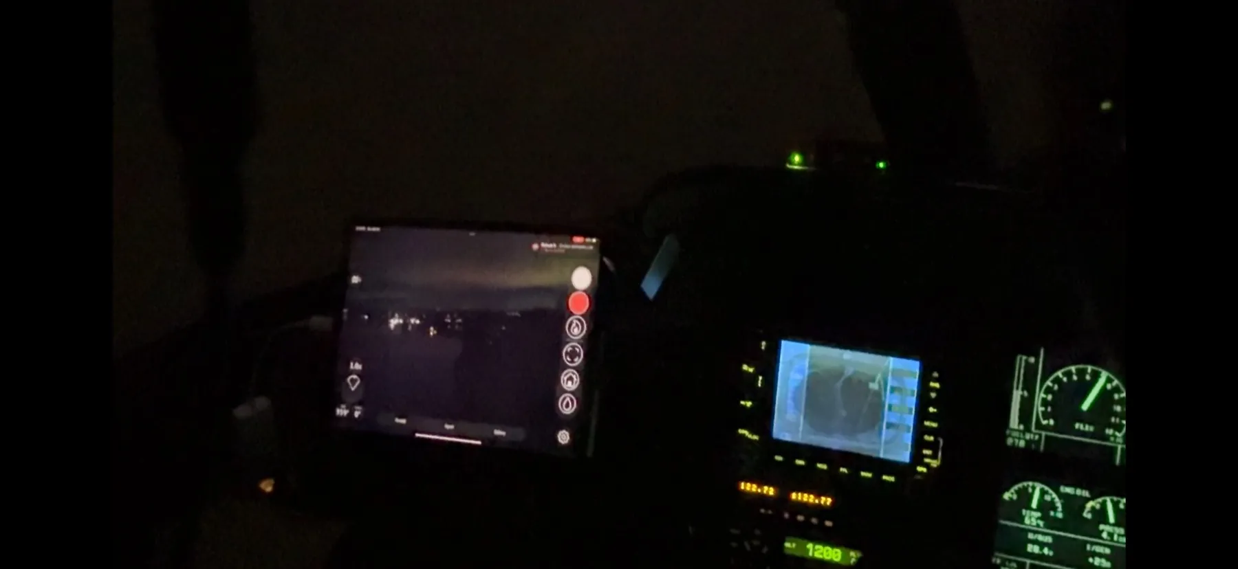 Illuminated tablet and instruments inside an aircraft cockpit after dark